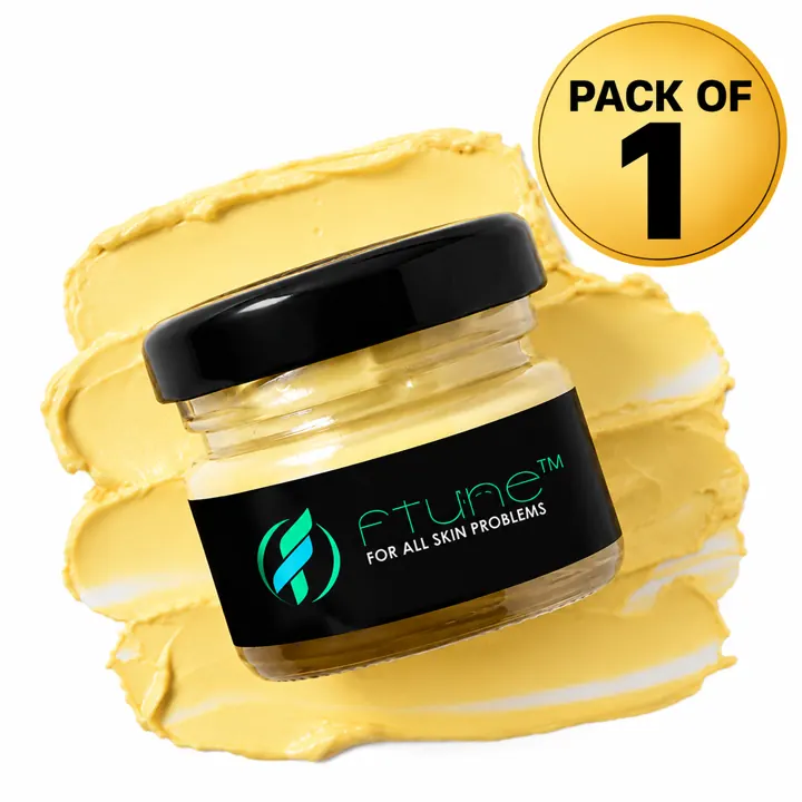 Ftune Cream in a glass jar with a black lid, resting on a swatch of the yellow cream
